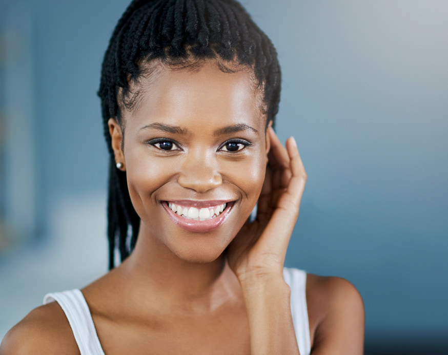 Young woman with a perfectly white teeth is happily smiling