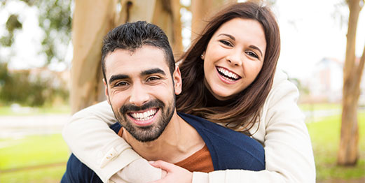 Young couple is smiling in the park